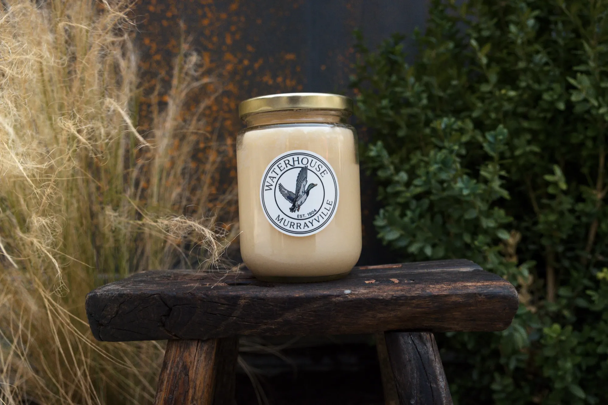 A jar of wildflower honey on a wooden stool at the Waterhouse Farm store