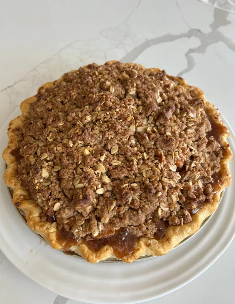 Apple crumble pie with an oat topping in a flaky crust