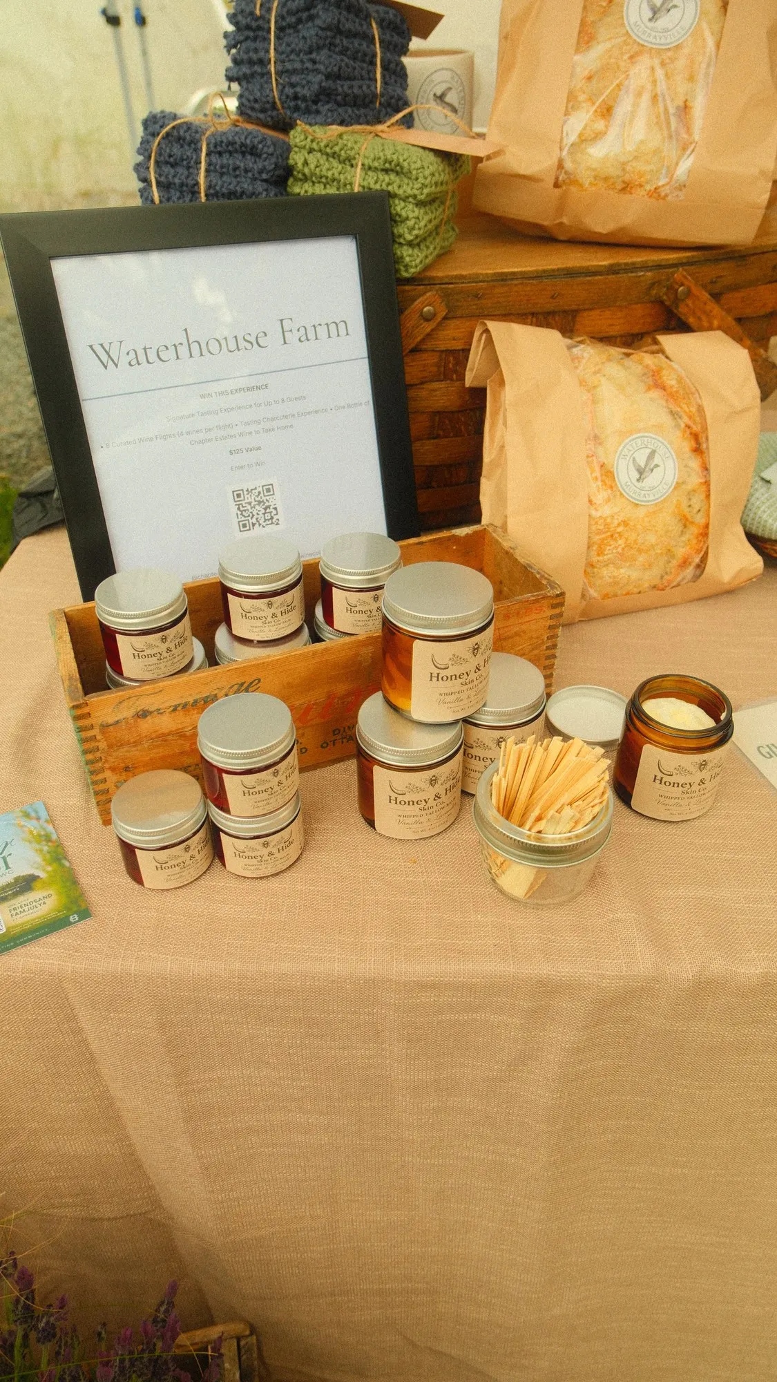 Waterhouse Farm market table with bread, hive goods, and handmade cloths